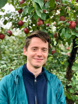 Headshot of Jon Richardson in an apple orchard in Minnesota 
